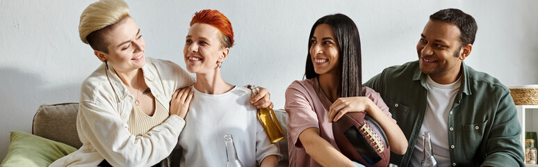 Diverse group sitting closely together on a couch, enjoying each others company.