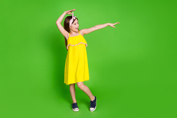 Full length photo of girlish pretty little lady dressed yellow outfit having fun empty space...