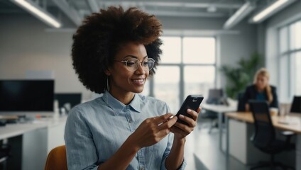 Successful afro-haired woman in modern office using smartphone