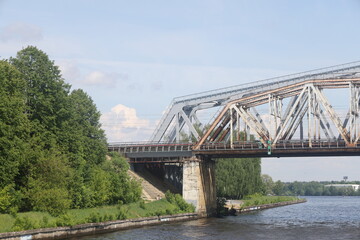 metal trusses of a bridge over a river, a bridge over a canal