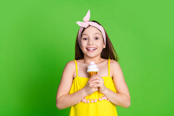 Photo of girlish pretty little lady dressed yellow outfit enjoying ice cream empty space isolated...