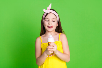 Photo of shiny attractive little lady dressed pin up outfit licking lips enjoying ice cream empty...