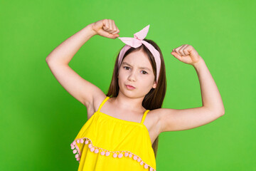 Photo of strong attractive little lady dressed pin up outfit showing muscles isolated green color...
