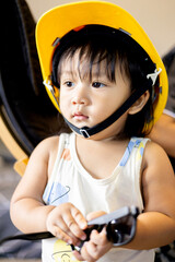Little Boy In An Yellow Construction Helmet With A Sunglass In His Hand