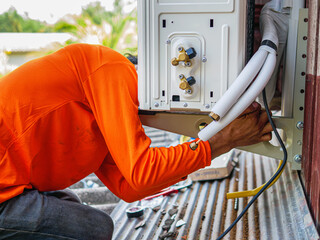 Air conditioning technicians install new compressor air in homes, Repairman fix air conditioning...