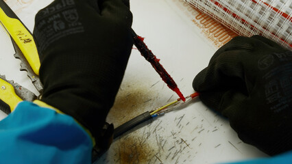 Close up of an electrical soldering wires with special equipment. Creative. Process of repairing...