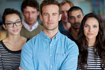 Office, unity and portrait of businessman with confidence for solidarity, team building and trust. Career, manager and employees with pride at work for creative internship, leadership or agency