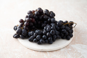 Dark grape on a white desk