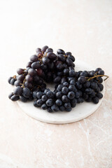 Dark grape on a white desk