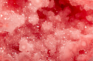 Amethyst red crystals. Gems. Mineral crystals in the natural environment. Texture of precious and semiprecious stones. Seamless background with copy space colored shiny surface of precious stones.