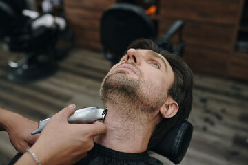 Man having his neckline shaved in barbershop