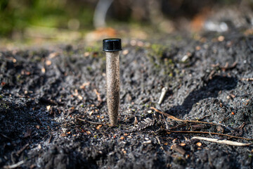 farmer holding soil, doing soil tests in her home laboratory. Looking at soil life and health