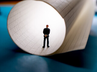 Man stands silhouetted at the end of tube,reflecting on the future