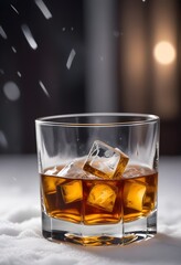 close-up of whiskey glass with ice on snow, ad shot.
