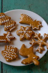 Painted traditional Christmas gingerbreads arranged on old vintage painted table in daylight,...