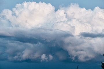 Scenic landscape with dramatic sky, tree, and distant building in the background as symbol of nature and travel