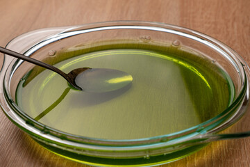 Hot water is poured into a bowl, in which green jelly is dissolved. Preparation of gelatin desserts.