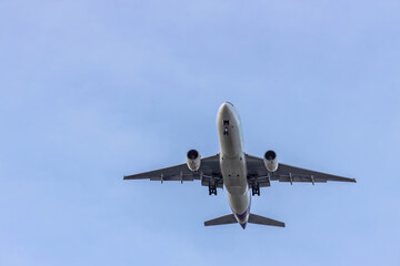 Airplane and sky, the plane is landing. Airplane take off on the blue sky, Aircraft flying on sky background. Passenger plane ready for landing. Low angle view of Airplane flying under blue sky.