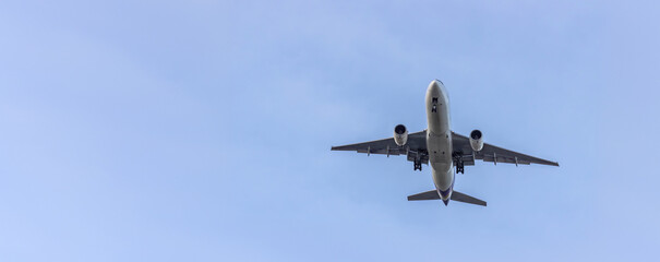 Airplane and sky, the plane is landing. Airplane take off on the blue sky, Aircraft flying on sky background. Passenger plane ready for landing. Low angle view of Airplane flying under blue sky.