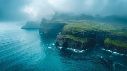 Breathtaking view of green-clad sea cliffs rising from the mist, offering a sense of awe and...