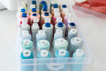 The seamstress's workplace. There are threads of different colors in the box for sewing.