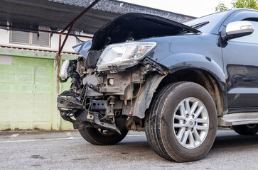 Front of a black car which was destroyed.