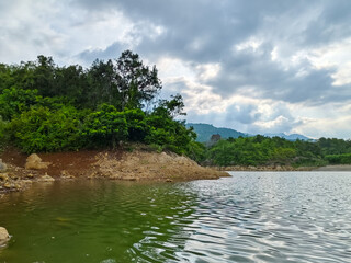 natural view of the lake at the foot of the mountain with the evening sky