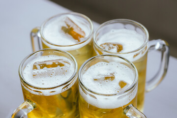 Close-up cropped photos of friends Clinking beer glasses