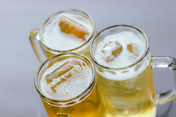 Close-up cropped photos of friends Clinking beer glasses