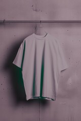 Minimalist Retro-Styled T-Shirt Mockup Hanging in Softly Lit Studio, Featuring Clean Geometric Design in Neutral Tones