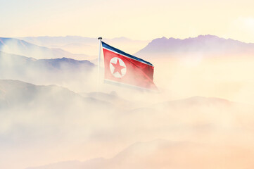North Korea flag disappears in beautiful clouds with fog.