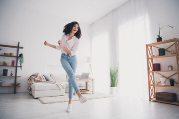 Full length photo of pretty cheerful lady wear casual shirt dancing having fun indoors room home house