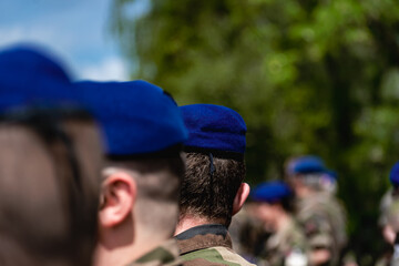 French soldier wearing camouflage uniform, close-up on his back with background