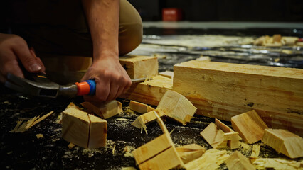 Carpentry works, carving wood block. Media. Using chisel for processing timber bar while assembling...