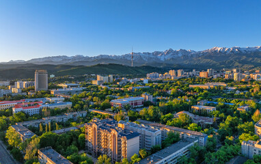 View from a quadcopter of the central part of the Kazakh city of Almaty on a spring morning against the backdrop of a mountain range