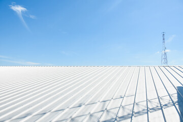 metal sheet roofing on commercial construction with blue sky © Aphisith