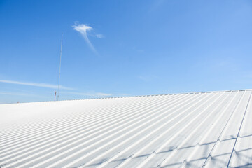 metal sheet roofing on commercial construction with blue sky