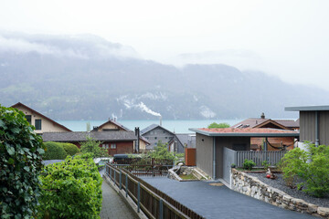 Brienz town on Lake Brienz by Interlaken, Switzerland, with snow covered Alps mountains in...