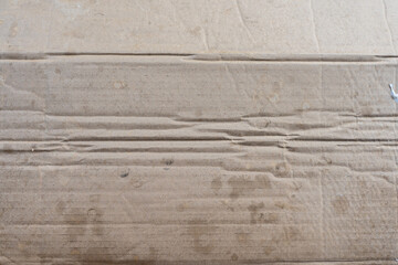 A rough, vintage brown cardboard texture with a grunge pattern and natural, aged appearance