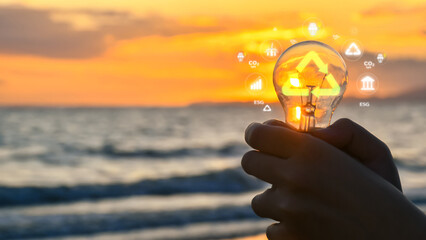 Energy conservation concept. Hand of human holding innovative light bulbs. Using alternative energy...