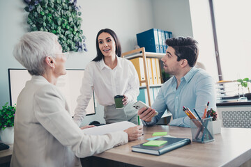 Photo of two employees mature boss woman talk chatting office team meeting professional...