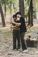 Asian couple sweet in tent inside on they camping trip, traveller relax and sleep togather in out...