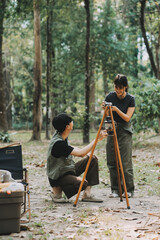 Asian couple sweet in tent inside on they camping trip, traveller relax and sleep togather in out...