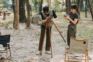 Asian couple sweet in tent inside on they camping trip, traveller relax and sleep togather in out...