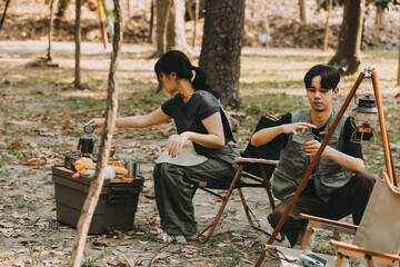 Asian couple sweet in tent inside on they camping trip, traveller relax and sleep togather in out door and camping trip