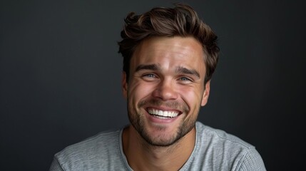 joyful man with a wide genuine smile showing off his perfect white teeth positive studio portrait