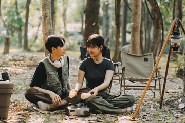 Asian couple sweet in tent inside on they camping trip, traveller relax and sleep togather in out...
