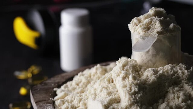 Rotating the dry sports protein powder with a measuring spoon embodies the concept of a healthy and vibrant life.