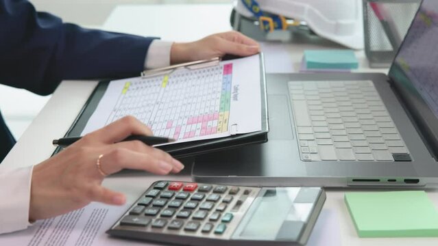 Expert woman asian female people review data number costing managerial account prepare monthly actual cost variance report at tax audit office. ESG sheet budget control ERP process service project.
