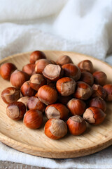 Fototapeta premium hazelnuts on a wooden plate 